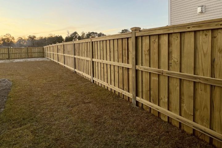 New wood privacy fence running the length of a back yard property line