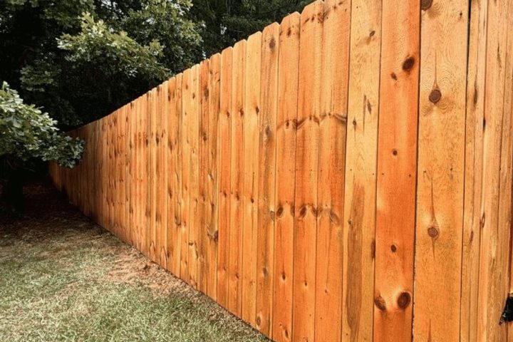 Stained wood privacy fence showing cedar tone and board spacing